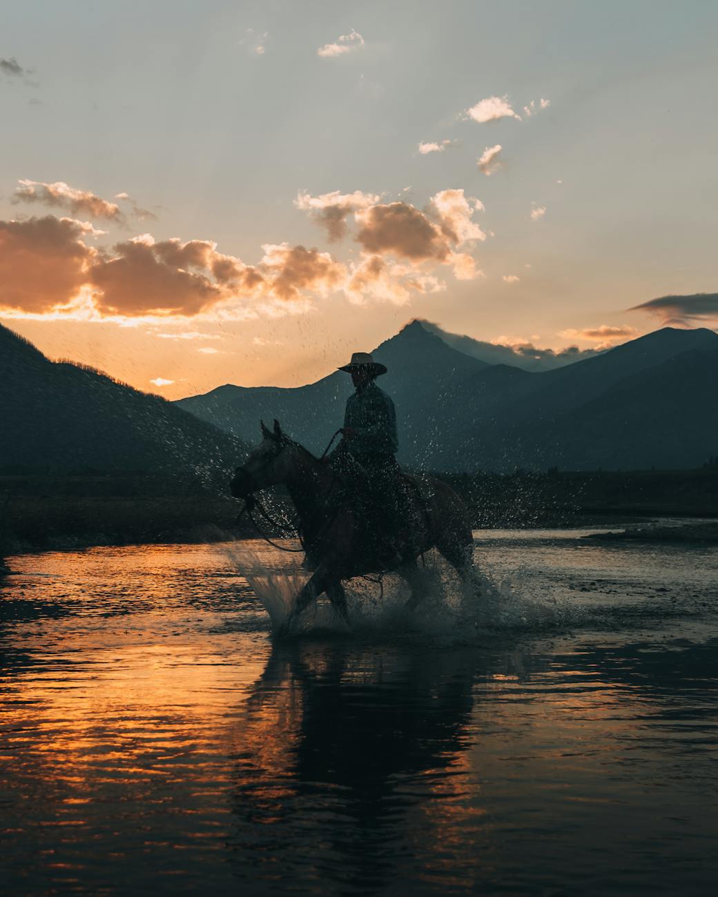 man riding horse across river