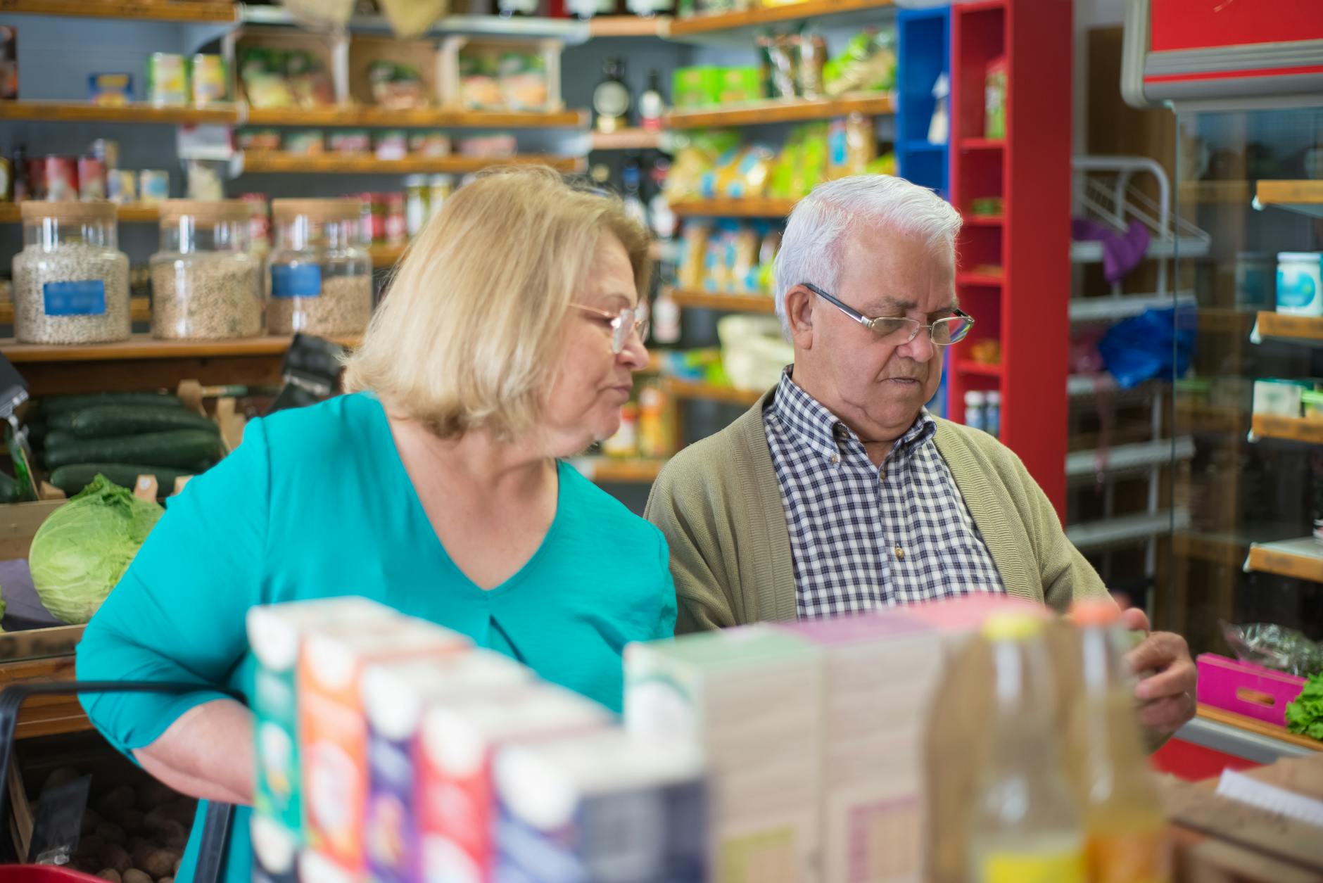 selective focus photo of elderly couple buying groceries