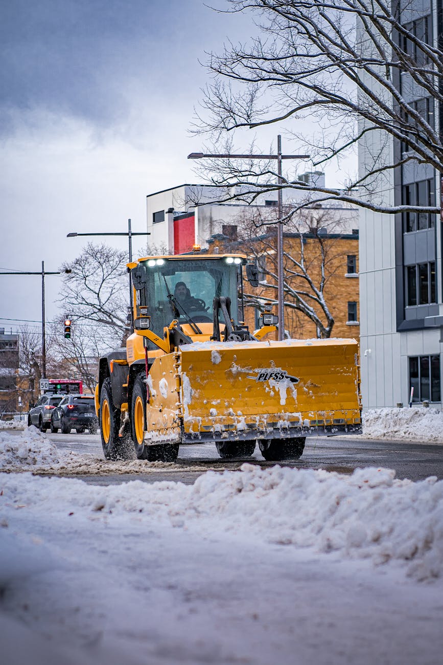yellow snow plow truck on road